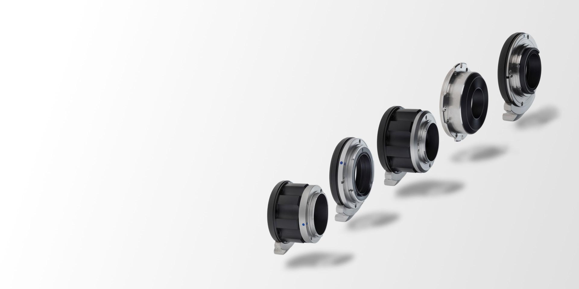 Five ZEISS lens mount adapters are displayed in a diagonal line against a light gradient background.