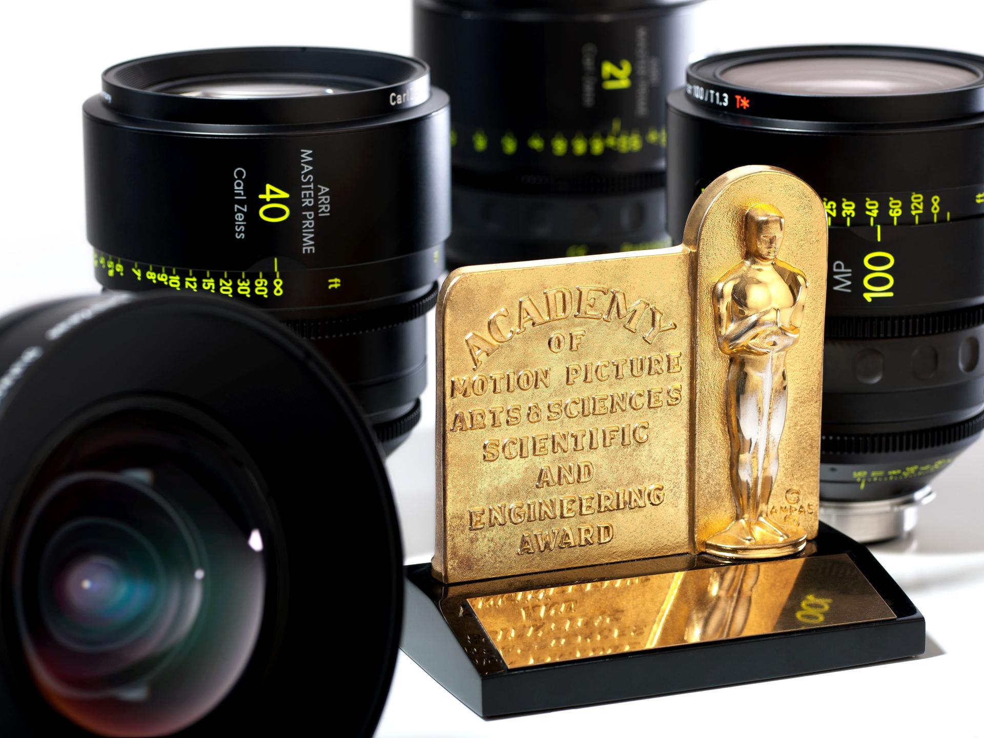 ZEISS camera lenses displayed around a Scientific and Engineering Award from the Academy of Motion Picture Arts and Sciences.