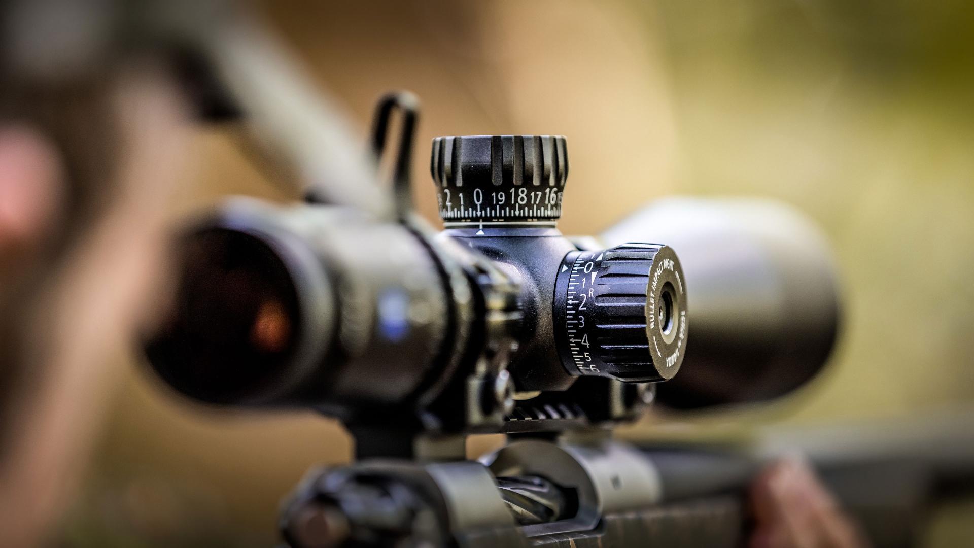 Close-up of a ZEISS riflescope adjustment turret with reticle illumination settings for precise brightness control