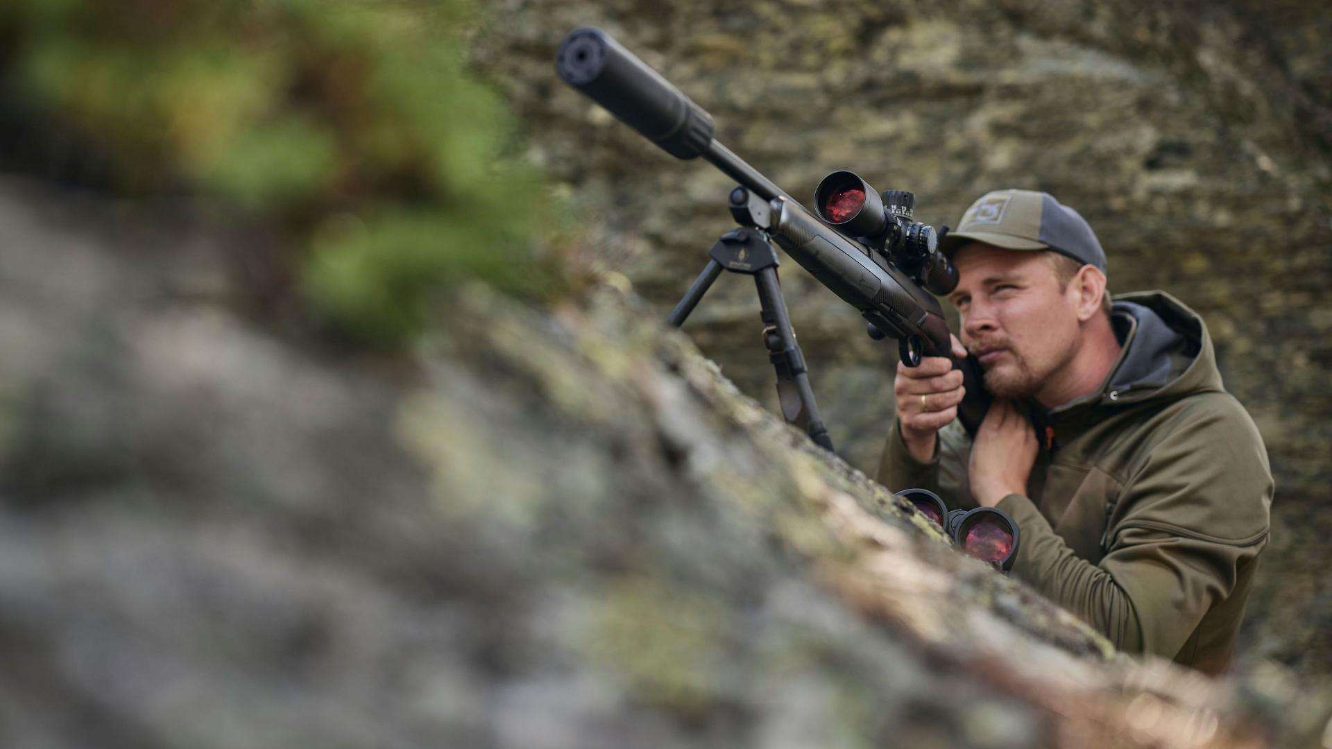 Hunter looking through a ZEISS LRP S3 riflescope in rocky terrain – symbolic for advanced optics with ED glass elements and high light transmission