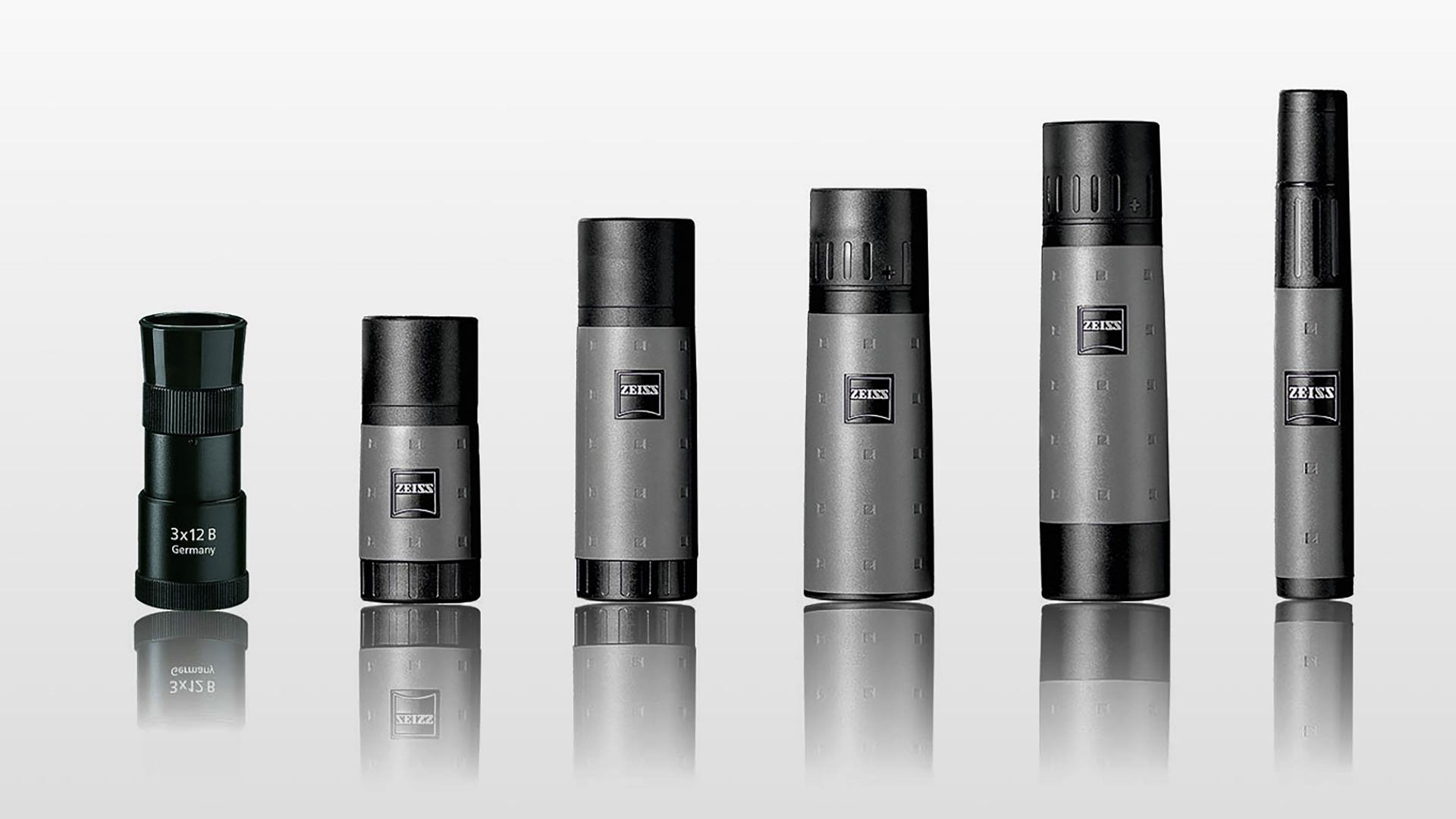 Six ZEISS monoculars of varying sizes are displayed in a row on a reflective surface against a gradient gray background.