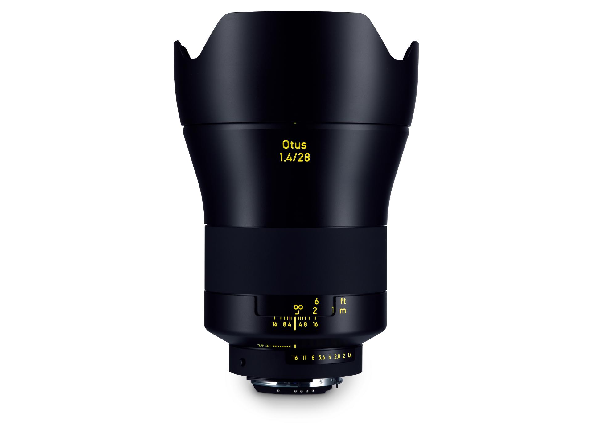 Black ZEISS Otus 1.4/28 camera lens with yellow labeling and a built-in lens hood, shown against a white background.