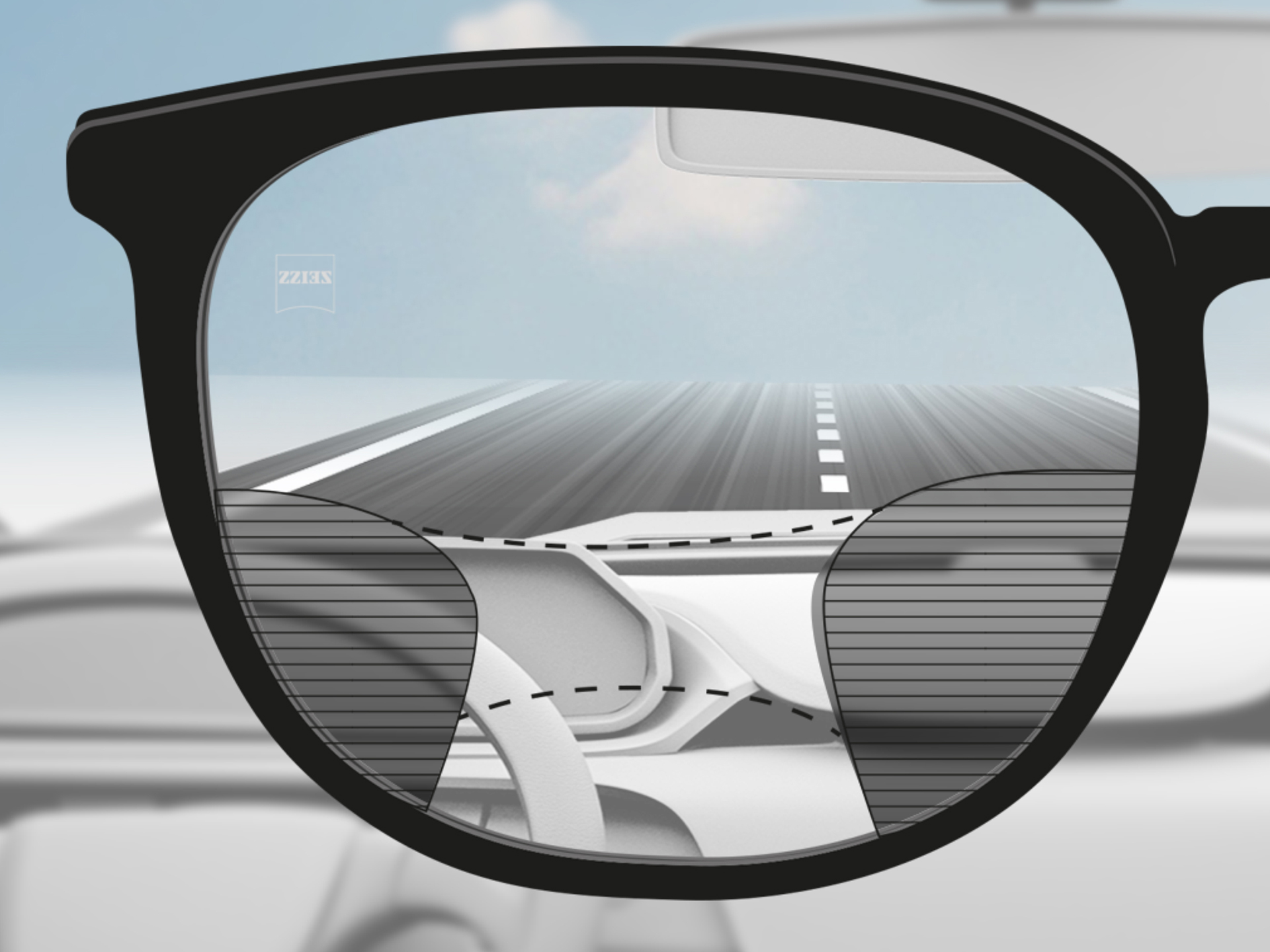 Immagine con punto di vista attraverso una lente progressiva ZEISS DriveSafe: le zone di visione sono adattate in modo che il conducente veda bene sia la strada sia il cruscotto.