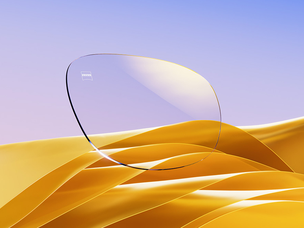 Rappresentazione in CGI di una lente da vista trasparente con un delicato riflesso dorato.